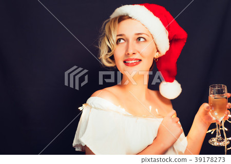 Beautiful blonde close-up in a Santa Claus hat Beautiful blonde close-up in a Santa Claus hat 39178273