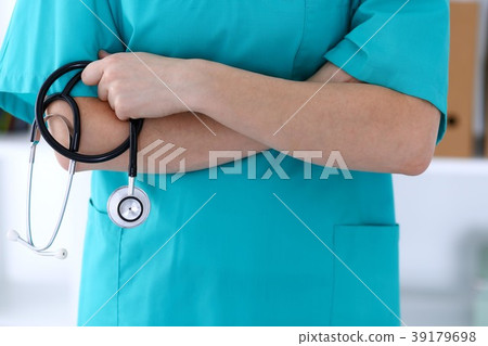 Unknown female doctor holds stethoscope closeup 39179698