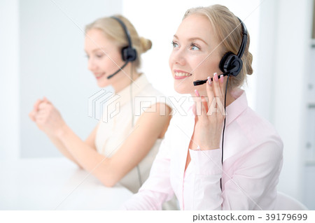 Image of bright call center. Focus on young Image of bright call center. Focus on young 39179699