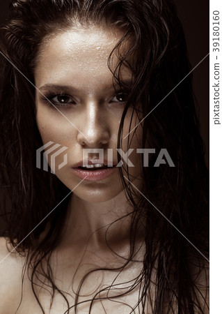 Beautiful girl with a bright make-up, wet hair and 39180160