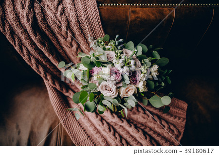 bridal bouquet on the couch with a knitted plaid bridal bouquet on the couch with a knitted plaid 39180617