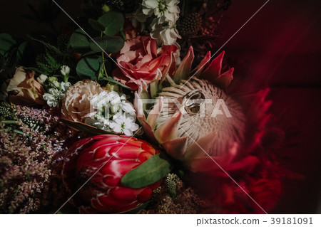 wedding rings on a bouquet of a bride 39181091