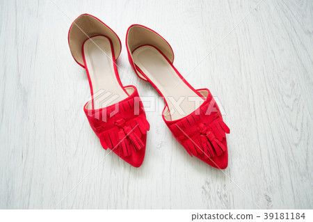 Red open shoes on a light wooden background 39181184