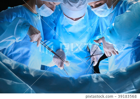 Group of surgeons at work in operating theater 39183568