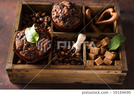 Chocolate muffins on a wooden box with grains of 39184690