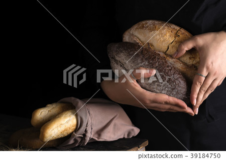 Close-up of woman hands as heart take fresh bread 39184750