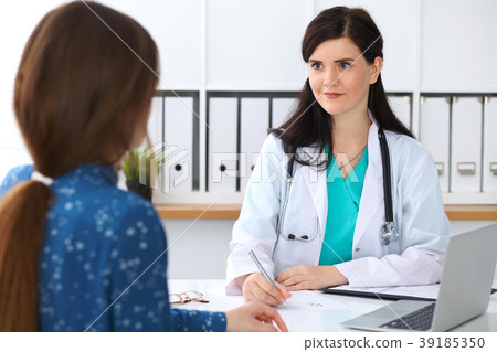 Beautiful female doctor and patient having a talk 39185350