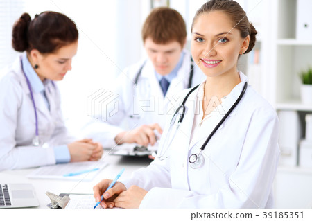 Happy female doctor keeping medical clipboard 39185351