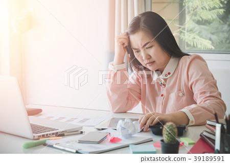 Sad business woman sitting in office Sad business woman sitting in office 39189591