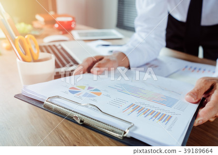 Businessman analyzing investment charts Businessman analyzing investment charts 39189664