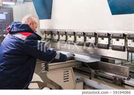 Operator working cut and bending metal sheet by 39194066