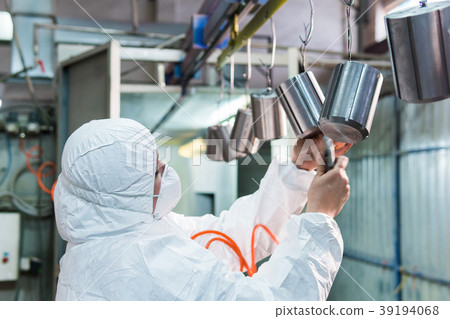woman in protective suit blows air on the metal 39194068