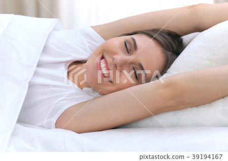 Beautiful young and happy woman sleeping while 39194167
