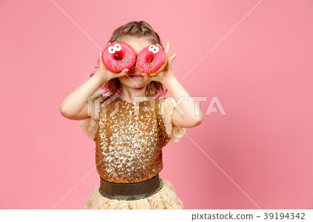 Little girl in dress with donuts 39194342