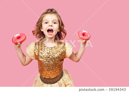 Little girl in dress with donuts 39194343