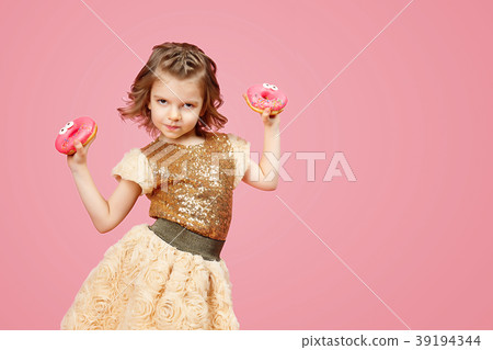 Little girl in dress with donuts 39194344