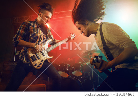 The musician plays an acoustic guitar. Scene The musician plays an acoustic guitar. Scene 39194665