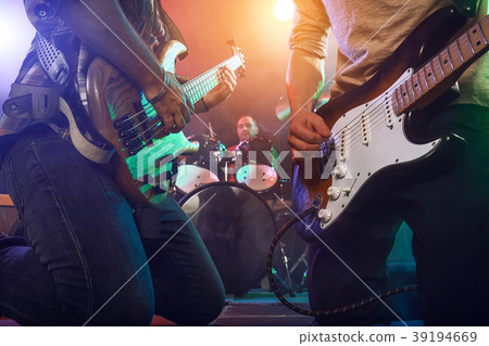 The musician plays an acoustic guitar. Scene The musician plays an acoustic guitar. Scene 39194669