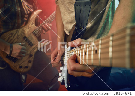 The musician plays an acoustic guitar. Scene The musician plays an acoustic guitar. Scene 39194671