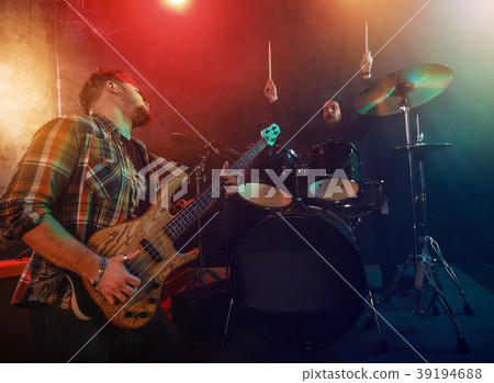 The musician plays an acoustic guitar. Scene 39194688