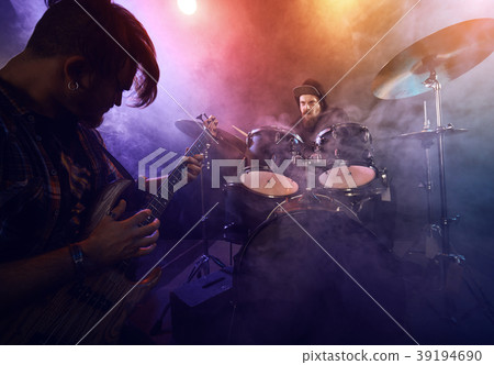 The musician plays an acoustic guitar. Scene 39194690