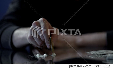 Close-up of male hand making lines of cocaine dose Close-up of male hand making lines of cocaine dose 39195863