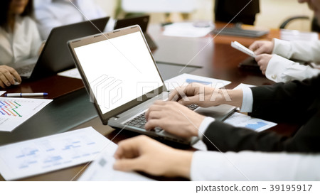 Businessman works on laptop at business meeting Businessman works on laptop at business meeting 39195917