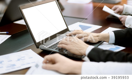 Man typing on laptop at meeting, team manager Man typing on laptop at meeting, team manager 39195933