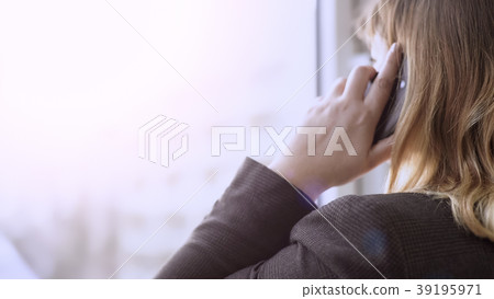 Businesswoman looking out of window while having Businesswoman looking out of window while having 39195971