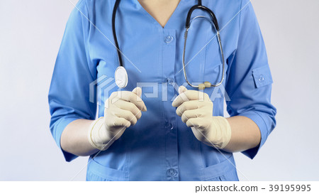 Medical worker in uniform and rubber gloves 39195995