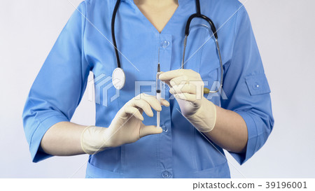 Woman doctor holding syringe going to make an Woman doctor holding syringe going to make an 39196001