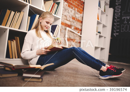 Teenage girl in a library 39196574