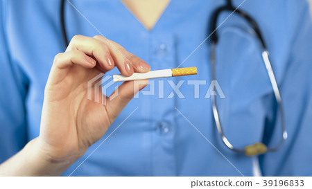 Female therapist showing cigarette, warning about 39196833