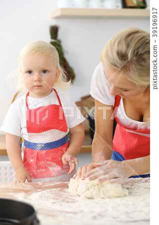 Mother and her cute daughter hands prepares the Mother and her cute daughter hands prepares the 39196917