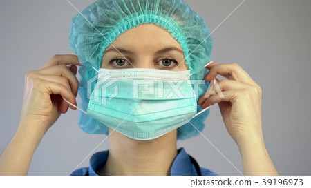 Surgeon putting on mask, doctor preparing for the Surgeon putting on mask, doctor preparing for the 39196973