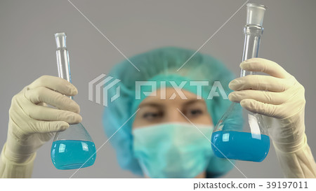 Medical researcher holding test tubes with liquid 39197011