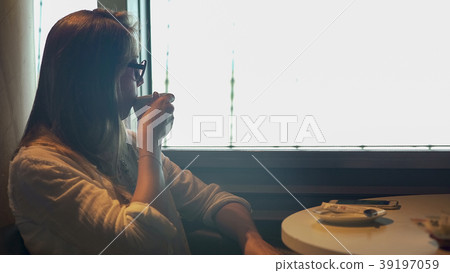 Beautiful young woman enjoying tasty coffee Beautiful young woman enjoying tasty coffee 39197059