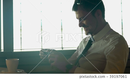 Young happy man watching movie on smartphone in Young happy man watching movie on smartphone in 39197061