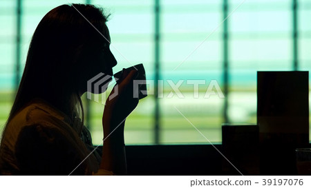 Beautiful woman waiting for plane at airport Beautiful woman waiting for plane at airport 39197076