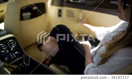 Successful businesswoman sitting in expensive auto Successful businesswoman sitting in expensive auto 39197117