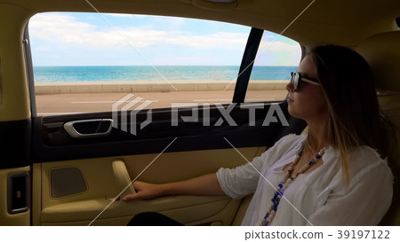 Rich lady having trip in luxury car at seafront Rich lady having trip in luxury car at seafront 39197122