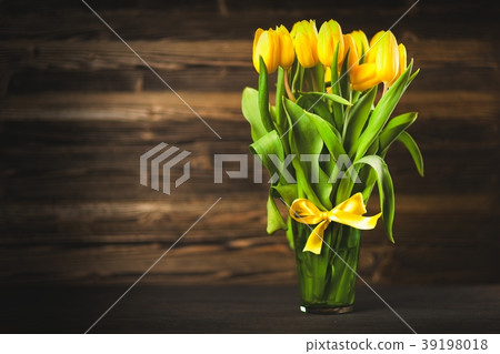 Yellow tulips on wooden background Yellow tulips on wooden background 39198018