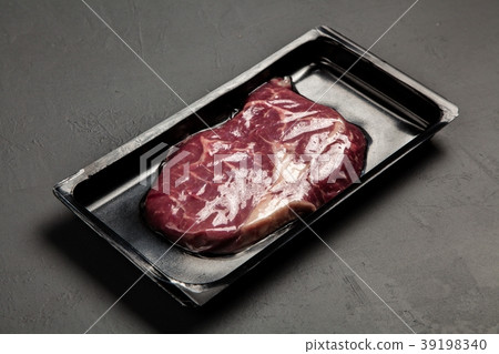 Raw steak in an airtight packaging Raw steak in an airtight packaging 39198340