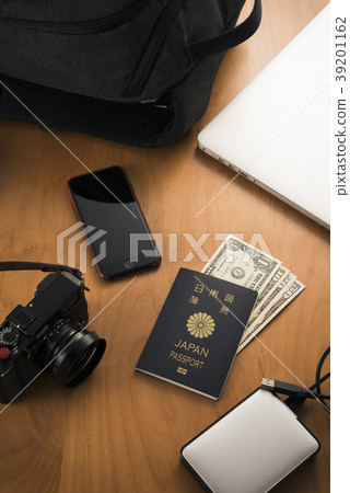 Passport and dollar bills, smartphones and digital cameras 39201162