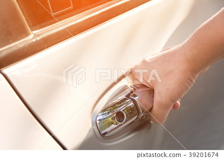 hand on handle opening a car door hand on handle opening a car door 39201674