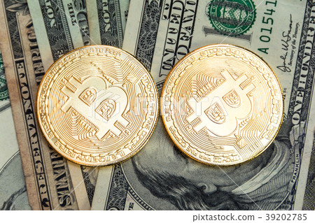 symbolic coins of bitcoin on banknotes dollars symbolic coins of bitcoin on banknotes dollars 39202785