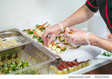 Chief at kitchen prepareing delicates, appetizers Chief at kitchen prepareing delicates, appetizers 39203005