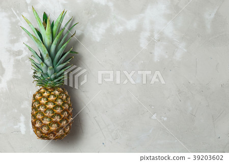 Whole pineapple fruit on grey concrete background 39203602
