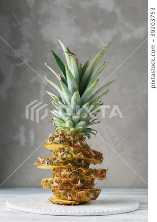 Fresh sliced pineapple on a wooden stand 39203753