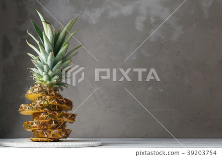 Fresh sliced pineapple on a wooden stand Fresh sliced pineapple on a wooden stand 39203754